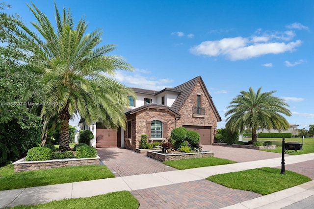 view of front of home featuring decorative driveway and an attached garage