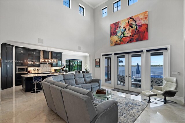 living room featuring visible vents, crown molding, baseboards, french doors, and marble finish floor