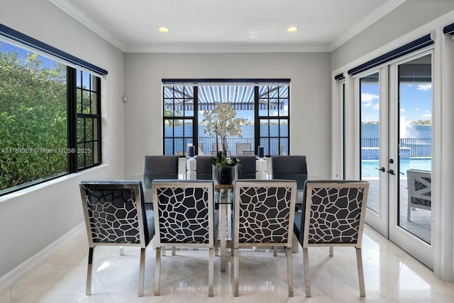 dining space with a wealth of natural light, baseboards, and ornamental molding