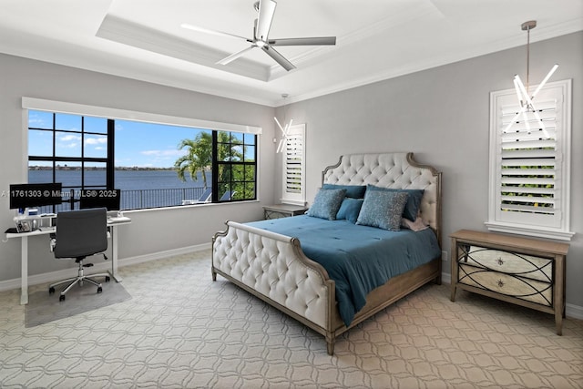 carpeted bedroom featuring baseboards, a raised ceiling, a ceiling fan, and crown molding