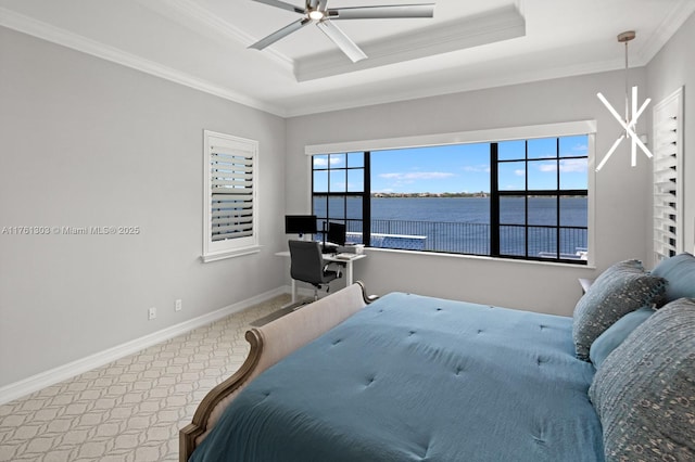 carpeted bedroom featuring ceiling fan, a tray ceiling, baseboards, and ornamental molding