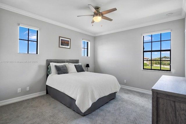 carpeted bedroom with ceiling fan, baseboards, multiple windows, and ornamental molding