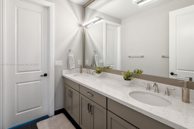 bathroom with a sink and double vanity