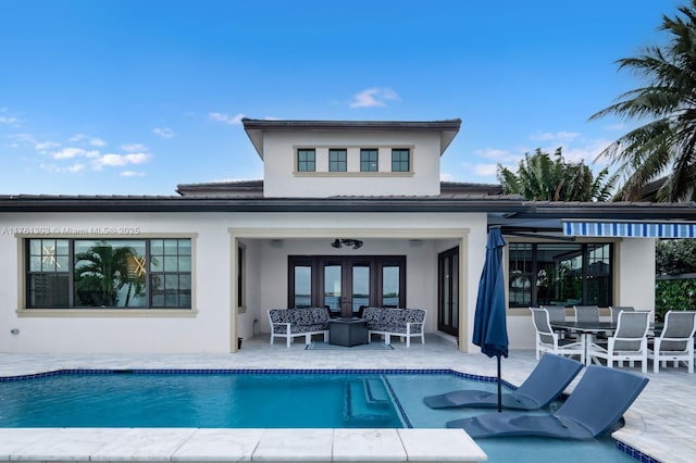 back of house featuring a patio, french doors, an outdoor pool, and stucco siding