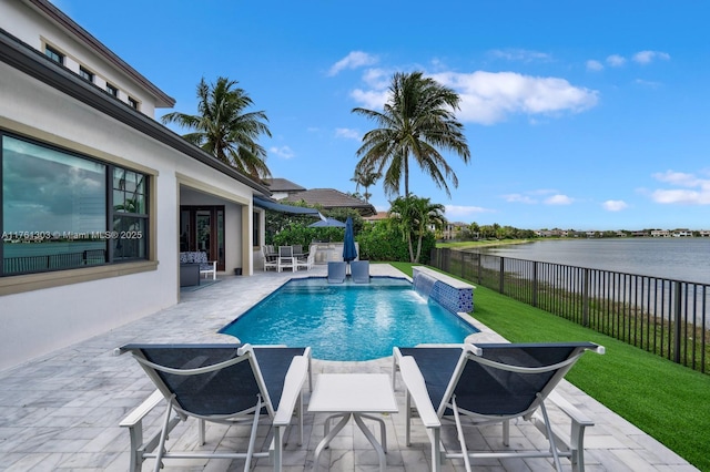 view of swimming pool featuring a water view, a patio, a fenced backyard, a yard, and a fenced in pool