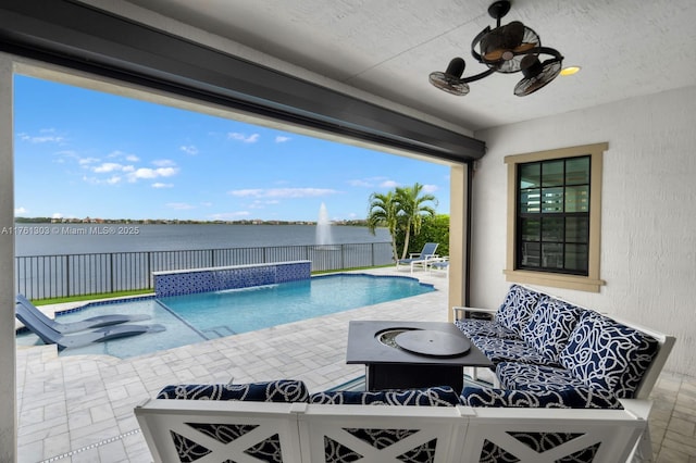 view of pool featuring a fenced in pool, a water view, a patio, a fenced backyard, and a ceiling fan