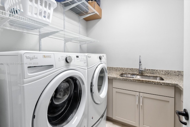 laundry area featuring washer and clothes dryer and a sink