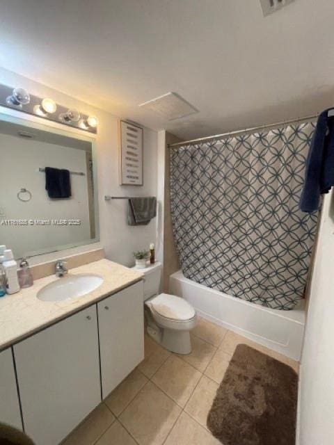 bathroom with tile patterned floors, shower / bathtub combination with curtain, toilet, and vanity