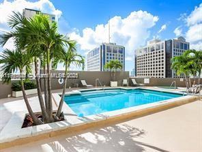 pool with a view of city and a patio area