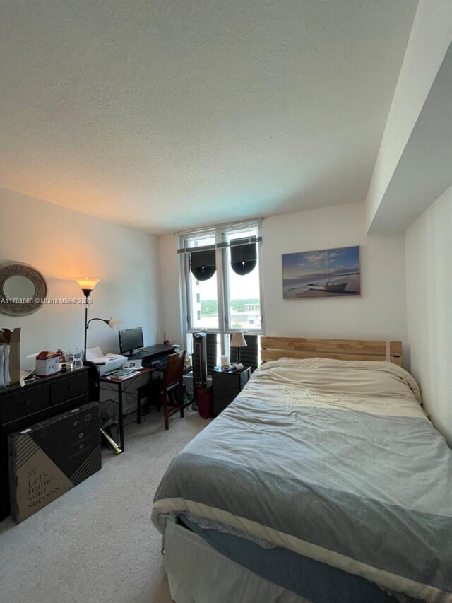 9066 SW 73rd Ct Unit 1002, Miami, FL 33156 - carpeted bedroom with a textured ceiling and a desk