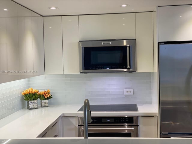 kitchen with white cabinetry, light countertops, modern cabinets, and appliances with stainless steel finishes