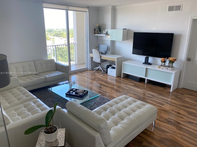 living room featuring visible vents and wood finished floors