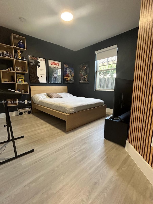 bedroom with wood finished floors and baseboards