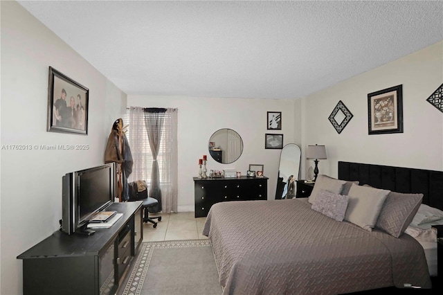 bedroom with light tile patterned flooring and a textured ceiling