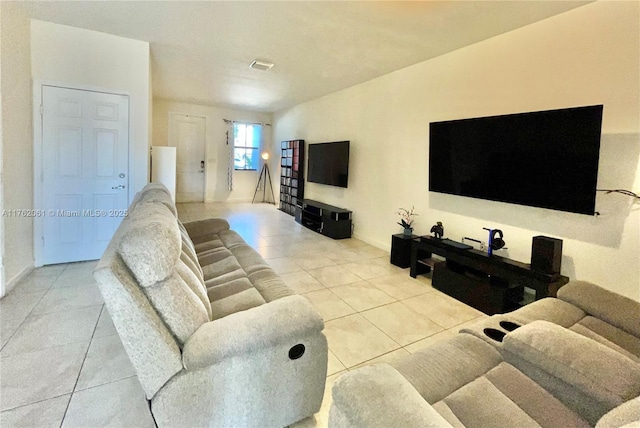 tiled living room featuring visible vents