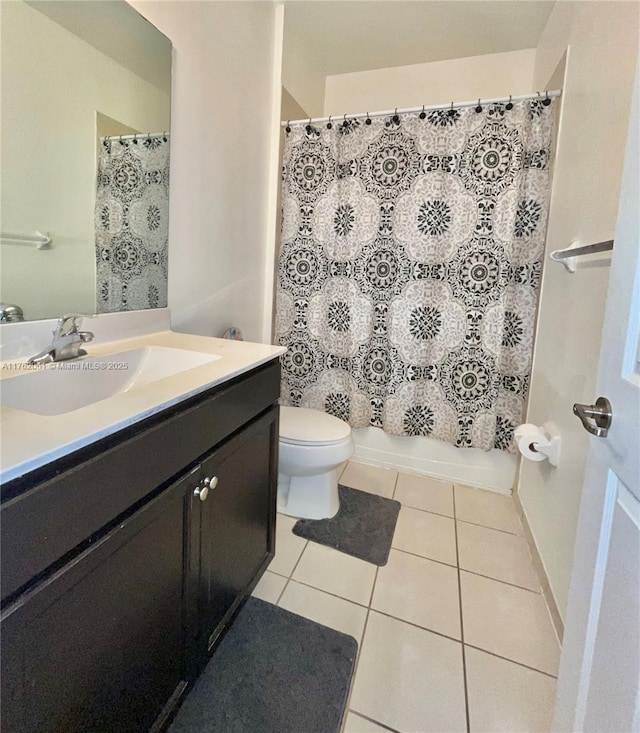 bathroom with shower / bath combo with shower curtain, toilet, vanity, and tile patterned flooring