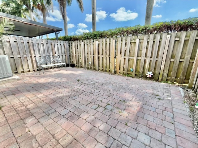 view of patio / terrace with central air condition unit and a fenced backyard