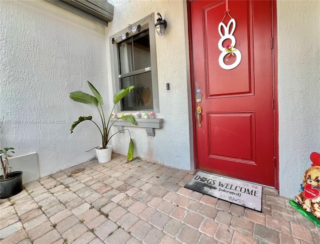 property entrance with stucco siding