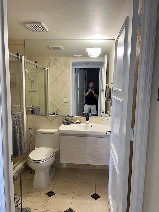 full bathroom with visible vents, a shower stall, toilet, tile patterned floors, and vanity