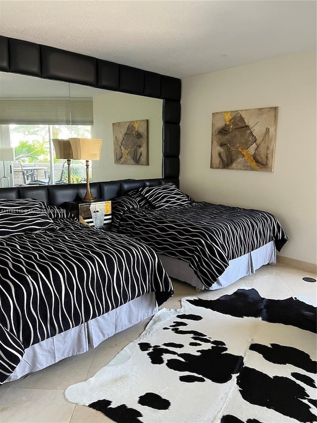 tiled bedroom with a textured ceiling