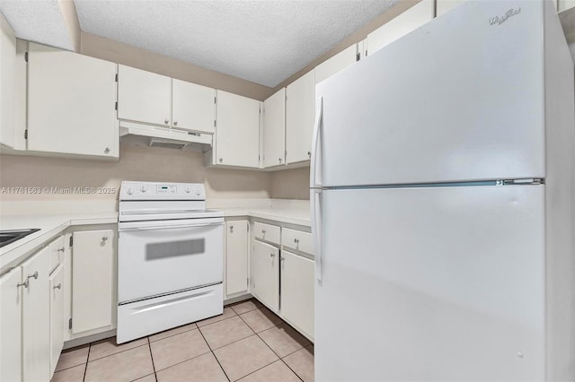 kitchen featuring white appliances, light tile patterned floors, light countertops, under cabinet range hood, and a textured ceiling