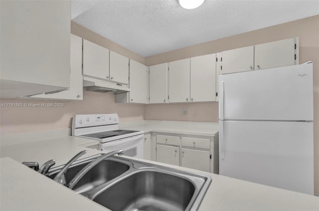 kitchen featuring white appliances, light countertops, under cabinet range hood, and a textured ceiling