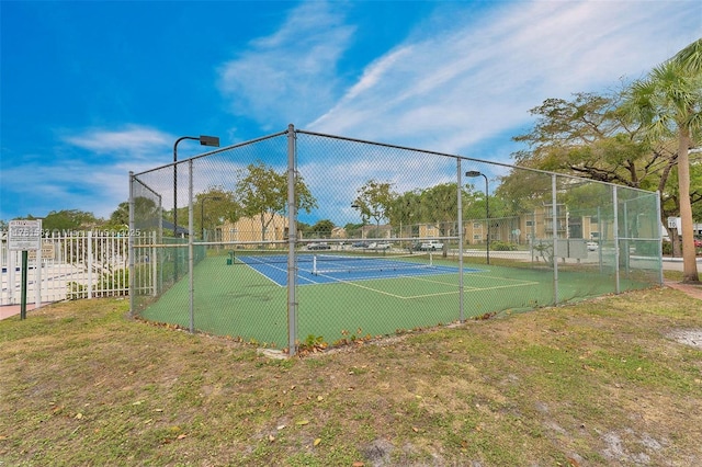 view of sport court with fence