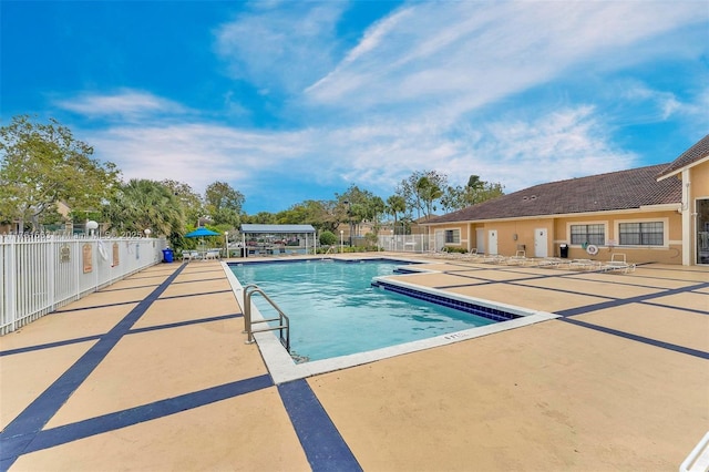 community pool featuring a patio area and fence