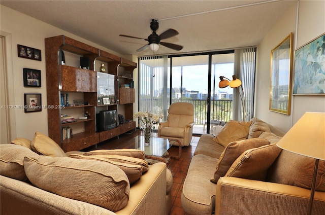 living area featuring expansive windows and a ceiling fan