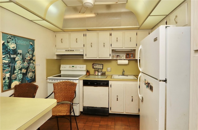 kitchen with a sink, white appliances, light countertops, a ceiling fan, and under cabinet range hood