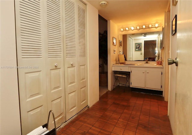 bathroom with vanity and a closet