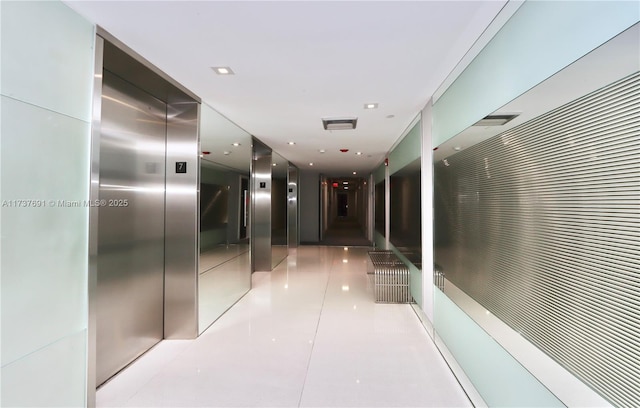 hall with visible vents and elevator