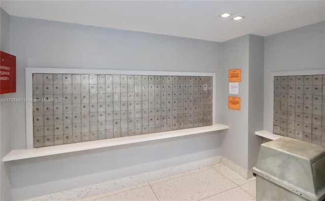 bathroom with baseboards and mail area