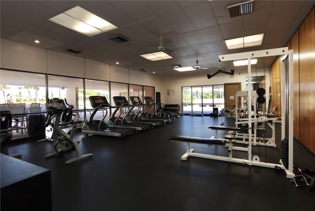 exercise room featuring a paneled ceiling and visible vents