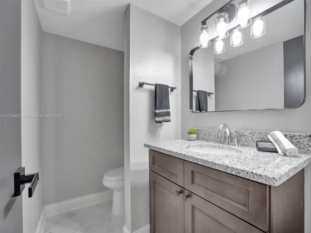 bathroom featuring vanity, visible vents, baseboards, toilet, and marble finish floor