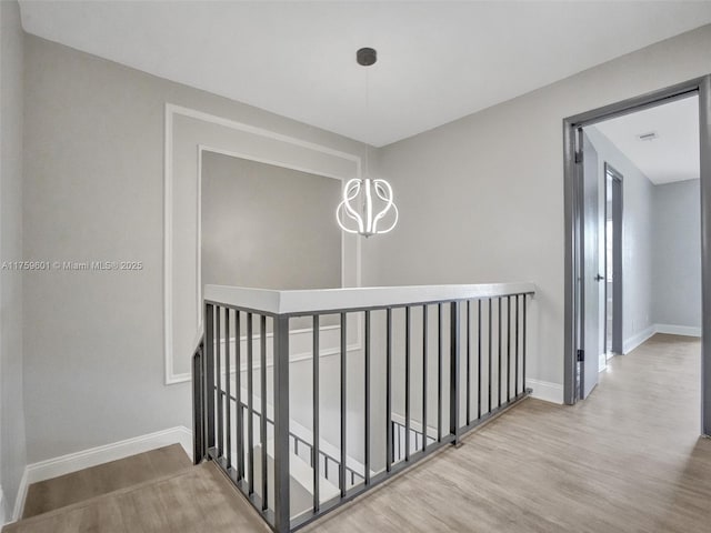 hall featuring baseboards and wood finished floors