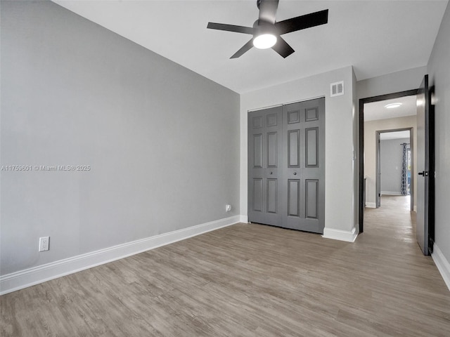 unfurnished bedroom with visible vents, baseboards, and light wood-style floors