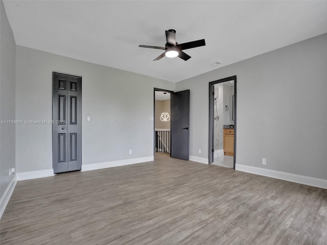 unfurnished bedroom with light wood-style flooring, baseboards, and ceiling fan