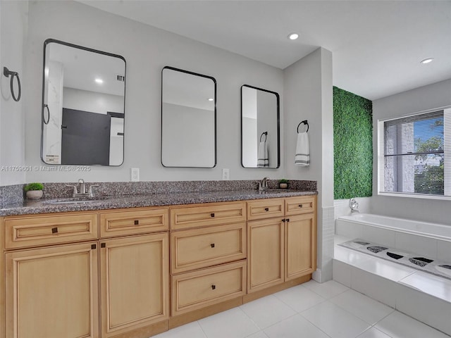 full bathroom with a sink, a garden tub, and double vanity