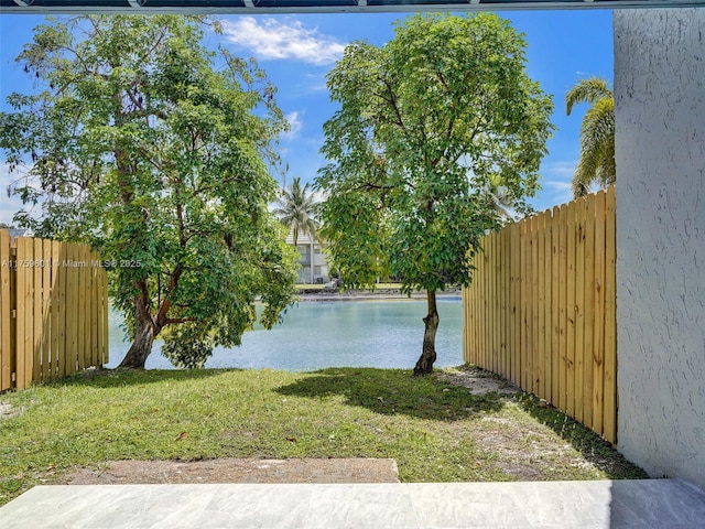 view of yard with fence and a water view