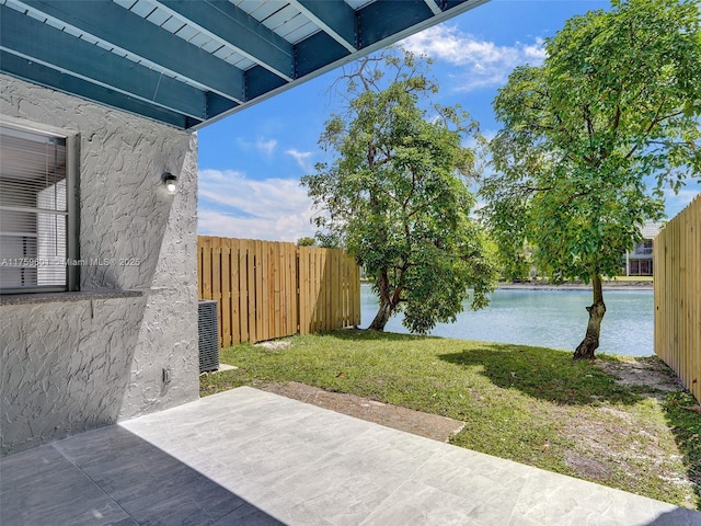 view of patio / terrace with central air condition unit, a water view, and fence