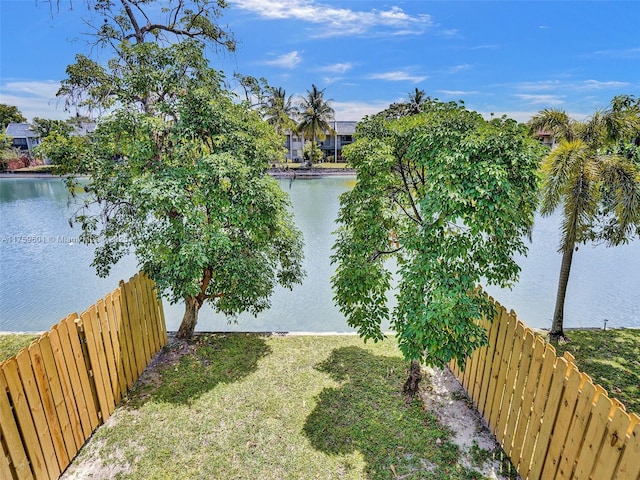 view of yard with fence and a water view