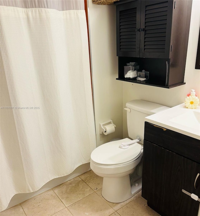 bathroom featuring tile patterned floors, toilet, and vanity