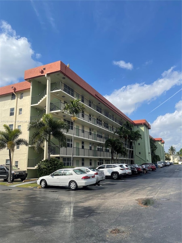 view of property featuring uncovered parking