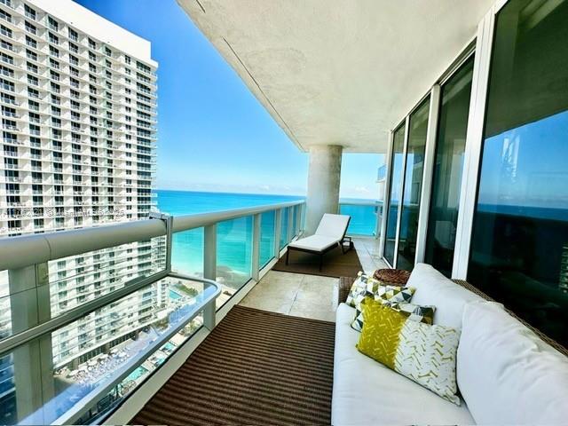 balcony with a water view and outdoor lounge area
