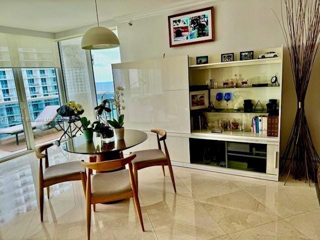 dining area featuring crown molding and expansive windows