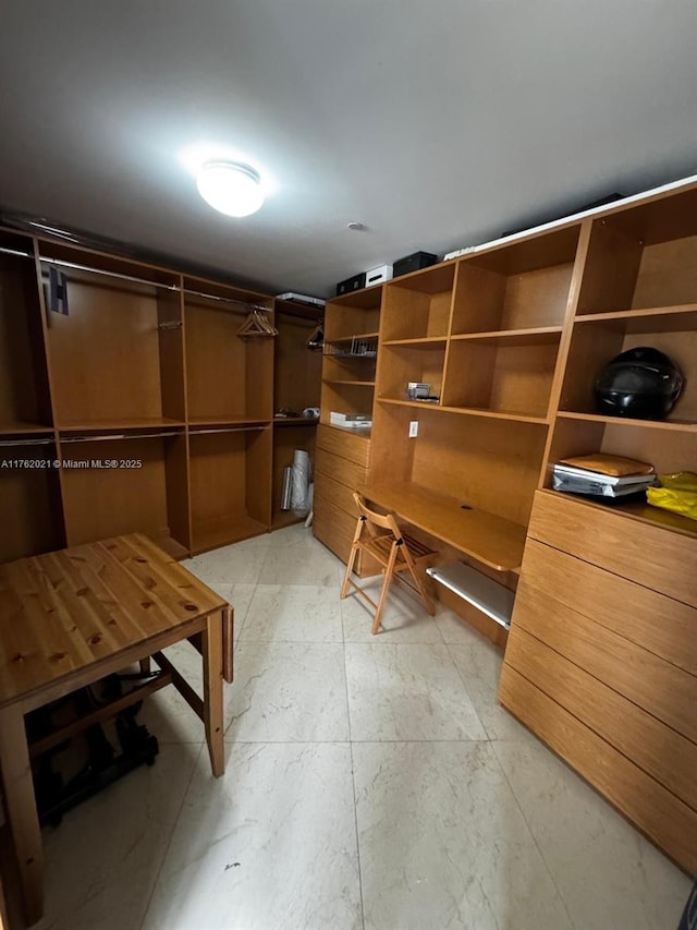 walk in closet featuring light floors