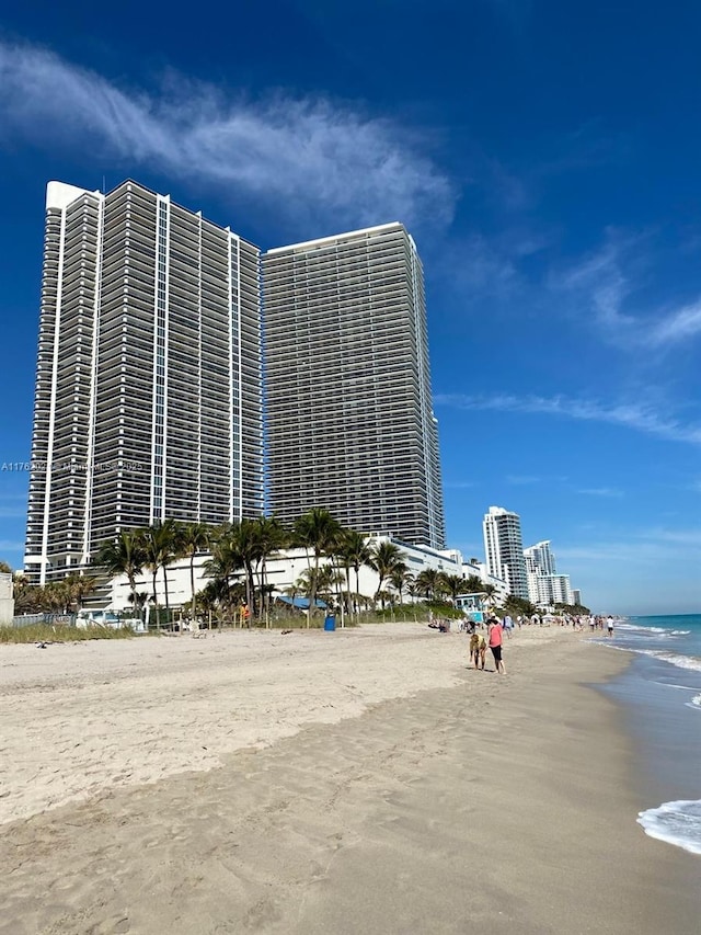 view of property with a water view and a view of the beach