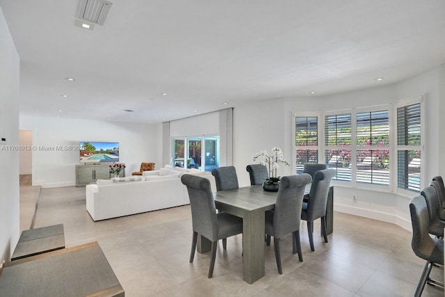 dining room with light tile patterned floors, recessed lighting, and baseboards