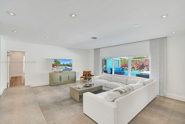 living room featuring recessed lighting and baseboards